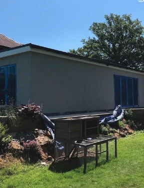 Finished smooth render on a house extension with new blue-framed windows